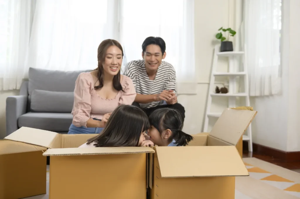 A family unpacking boxes in their freshly cleaned new Singapore home